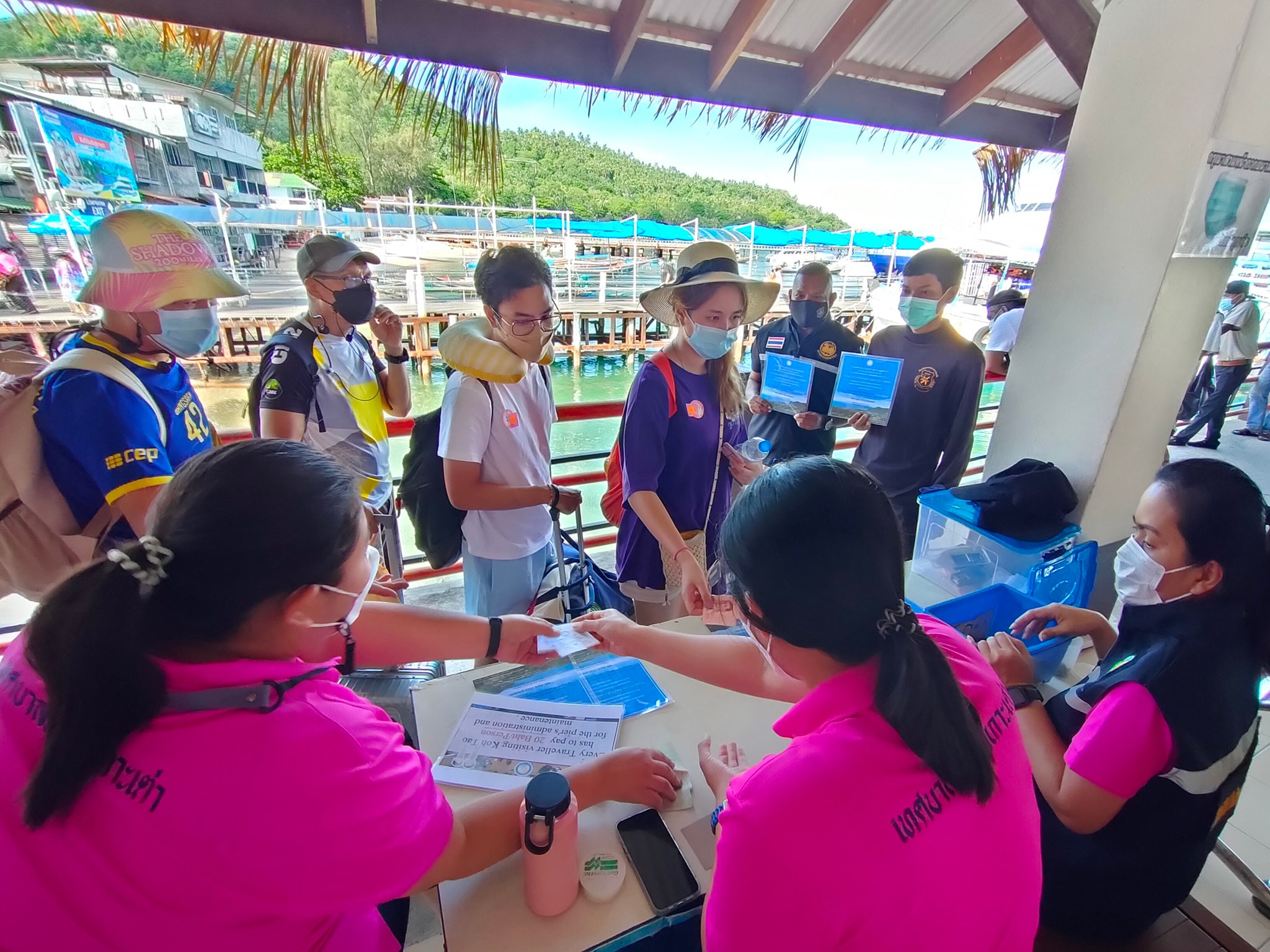 Photo credit: UNDP Thailand. Tourists paying a user fee of $0.60 to visit Koh Tao Island. The funds are used for coral reef restoration and waste management.