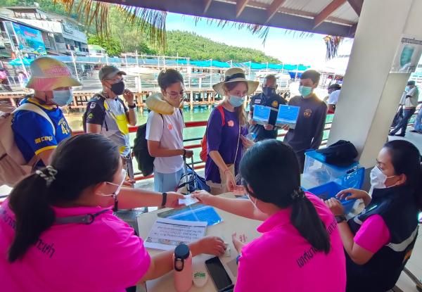 Photo credit: UNDP Thailand. Tourists paying a user fee of $0.60 to visit Koh Tao Island. The funds are used for coral reef restoration and waste management.